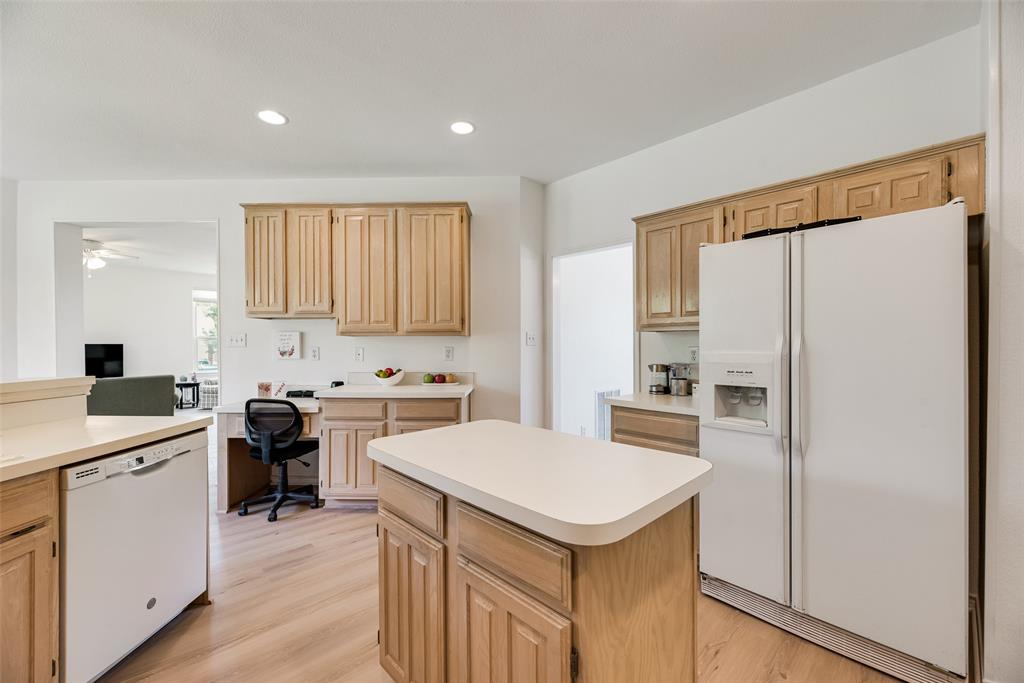 1406 West Peters Colony Road Carrollton, TX 75007 - Photo 7 of 29 a kitchen with white cabinets and white appliances