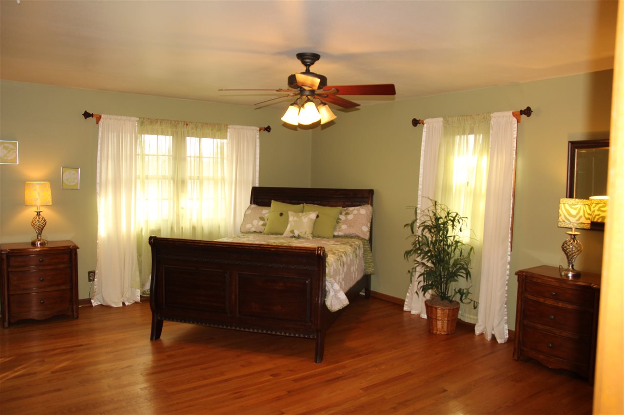 4972 Brookview Road Rockford, IL 61107 - Photo 13 of 22 a bedroom with bed and wooden floor