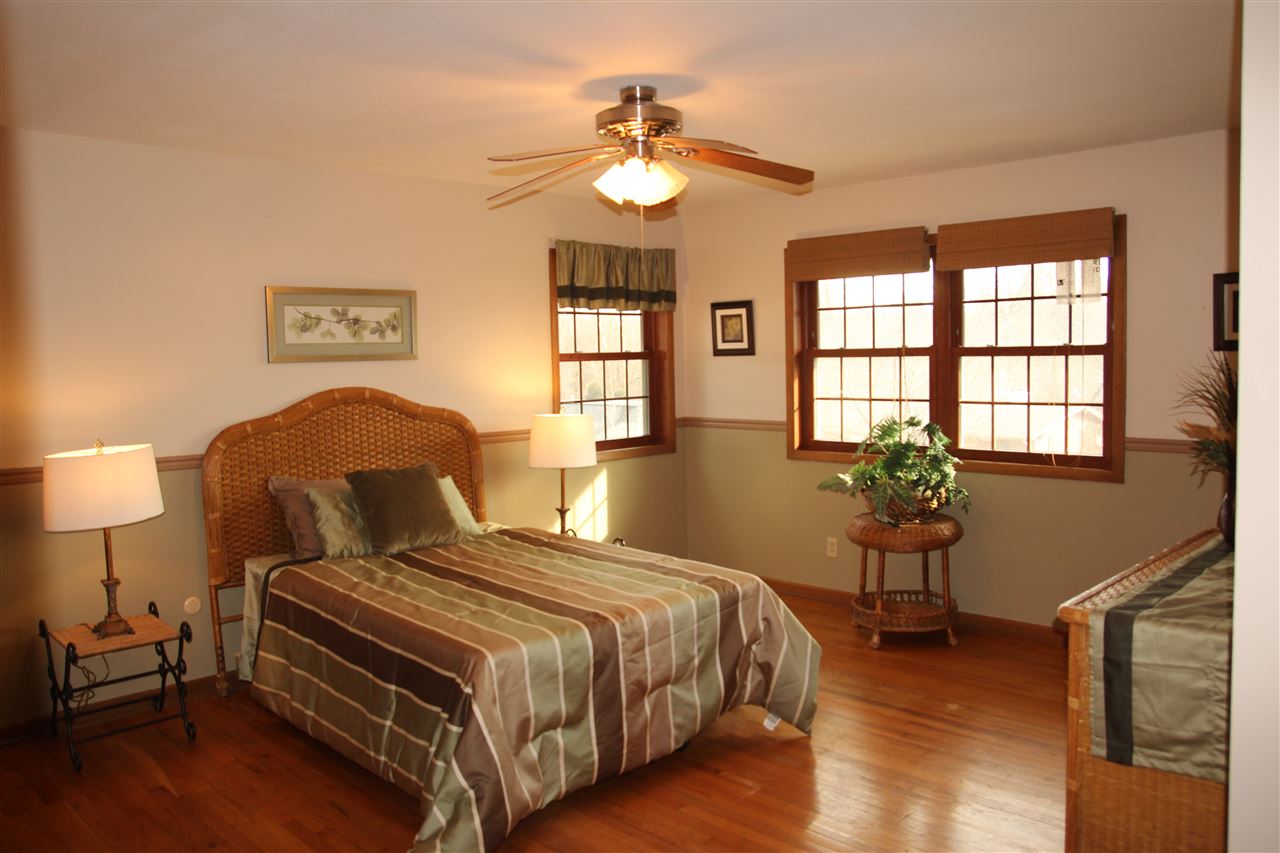 4972 Brookview Road Rockford, IL 61107 - Photo 16 of 22 a bedroom with a bed and wooden floor