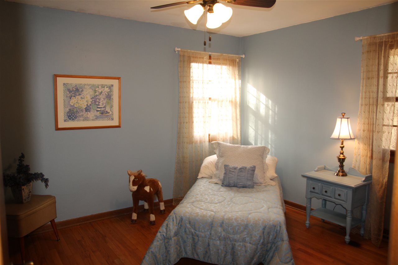 4972 Brookview Road Rockford, IL 61107 - Photo 17 of 22 a bedroom with a bed and a chandelier