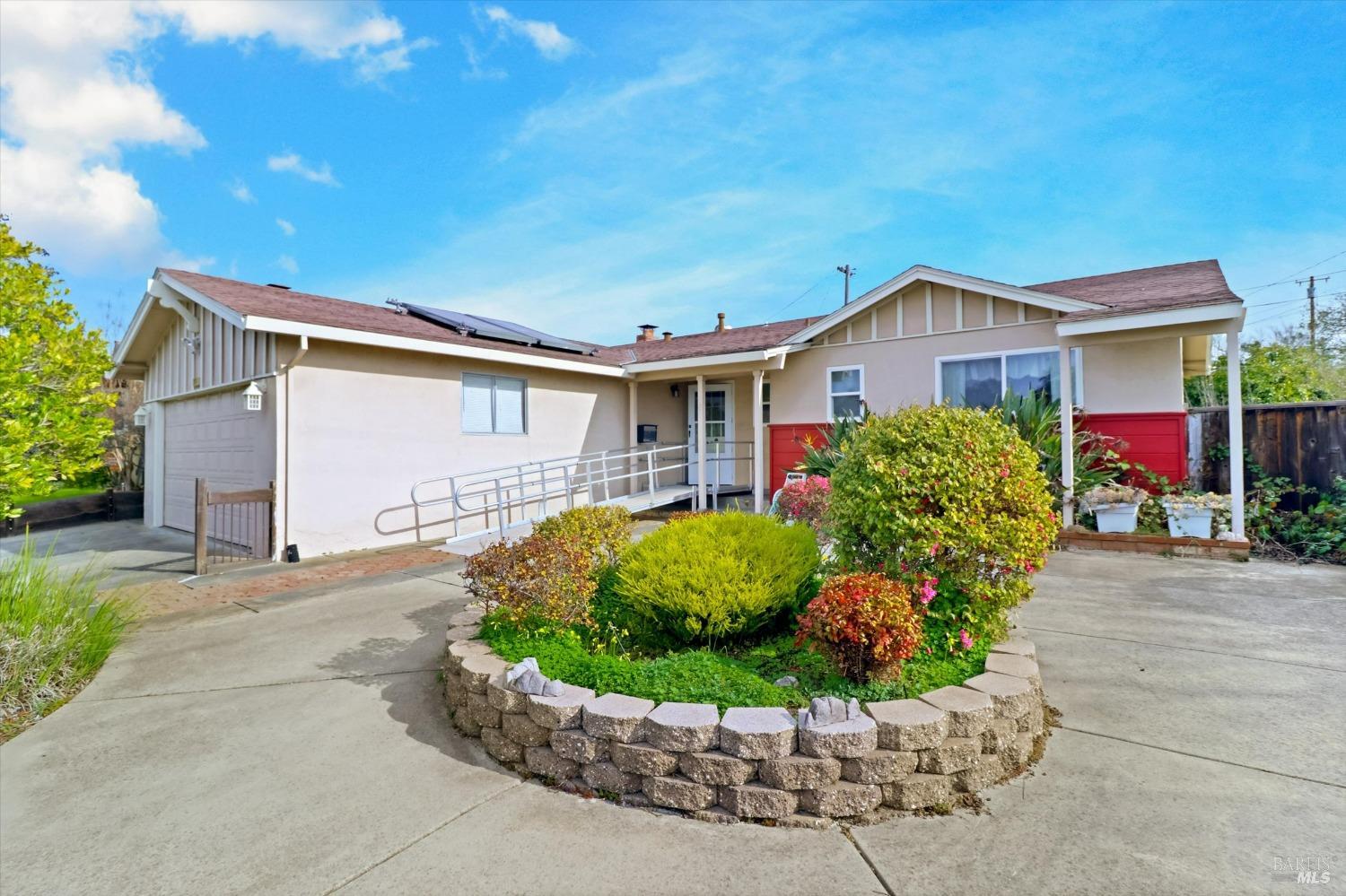 a front view of a house with a yard and outdoor seating