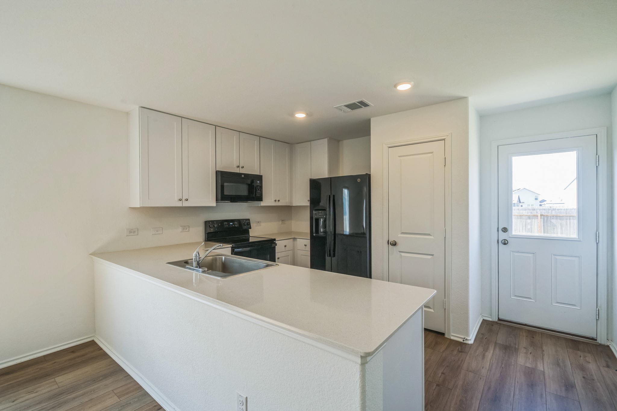 505 Sergeant Murphy Road Jarrell, TX 76537 - Photo 6 of 16 a kitchen with kitchen island a sink stainless steel appliances and white cabinets