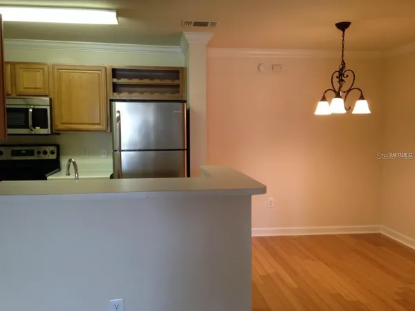 a kitchen with stainless steel appliances a refrigerator and a stove top oven
