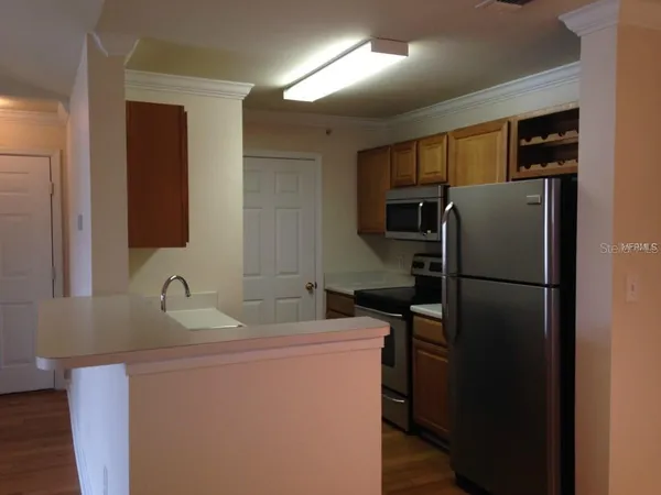 a kitchen with a refrigerator and a sink