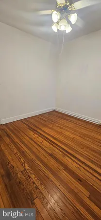 a view of an empty room and wooden floor
