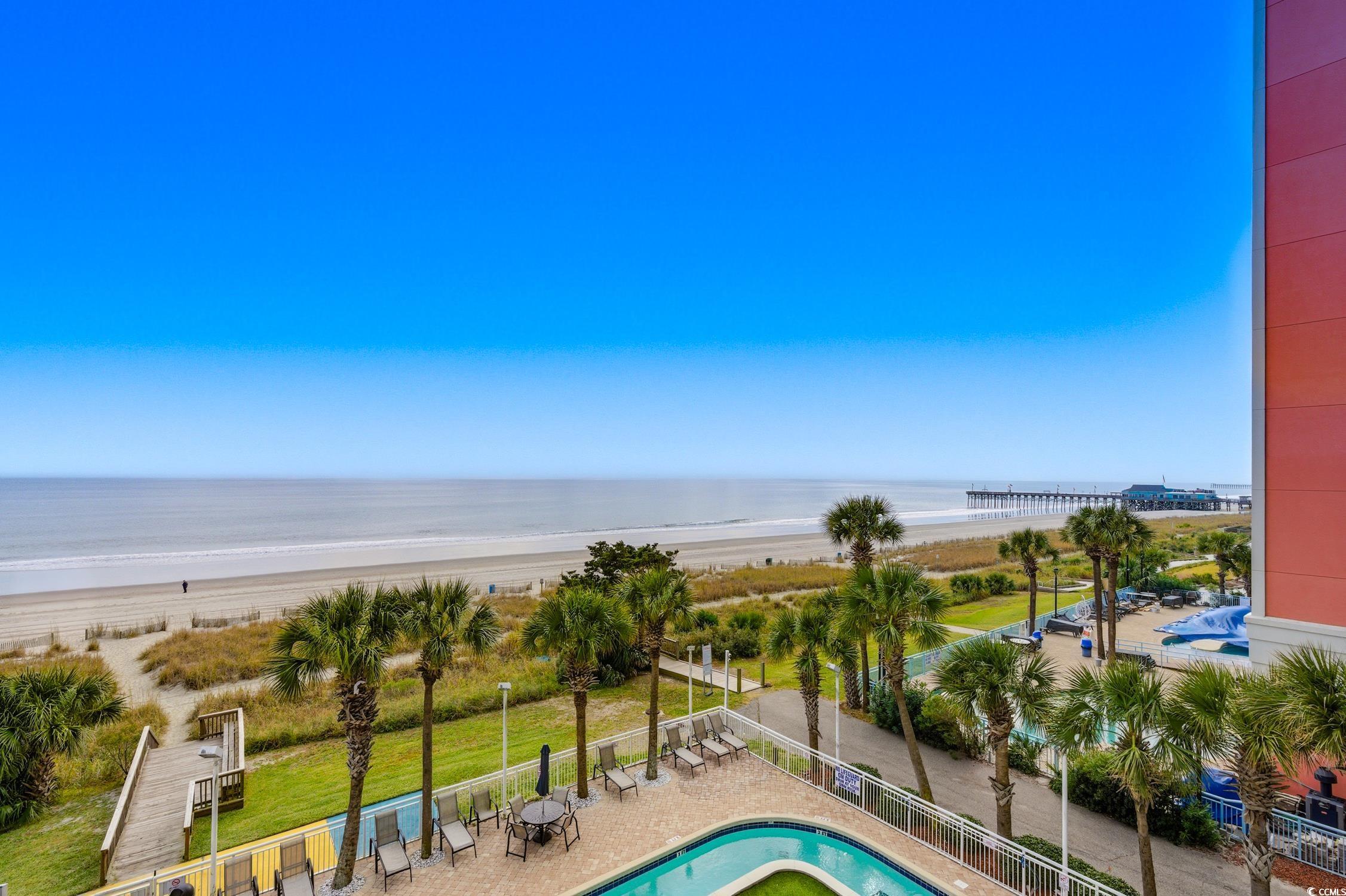 1702 North Ocean Boulevard, Unit 355 Myrtle Beach, SC 29577 - Photo 16 of 27 Community pool with view of water and beach and a patio area