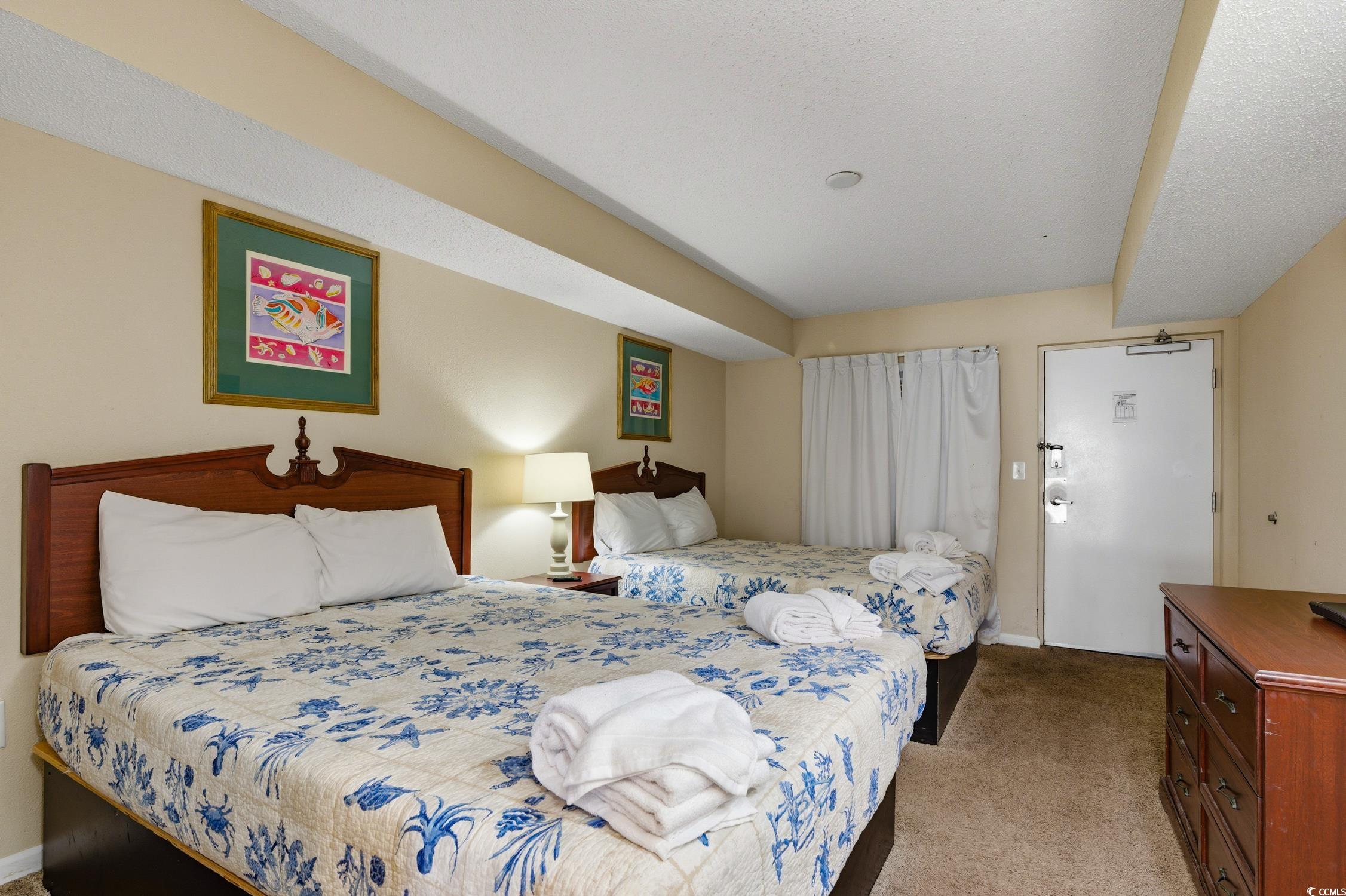 1702 North Ocean Boulevard, Unit 355 Myrtle Beach, SC 29577 - Photo 3 of 27 Bedroom with light colored carpet and baseboards