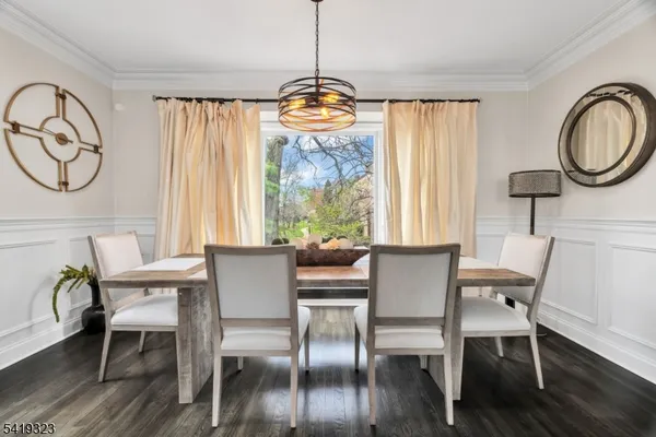 a dining room with furniture window and wooden floor