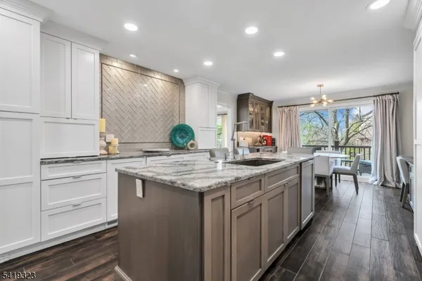 a kitchen with stainless steel appliances granite countertop a stove and cabinets