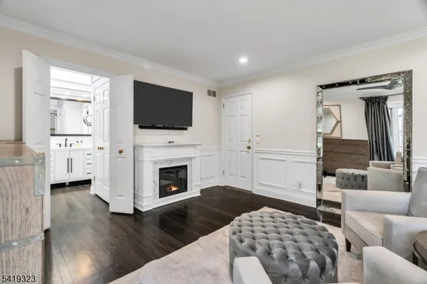 a living room with furniture fireplace and flat screen tv