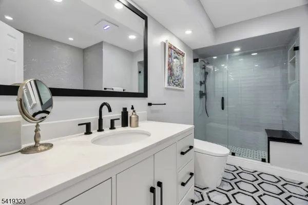 a bathroom with a sink toilet and shower