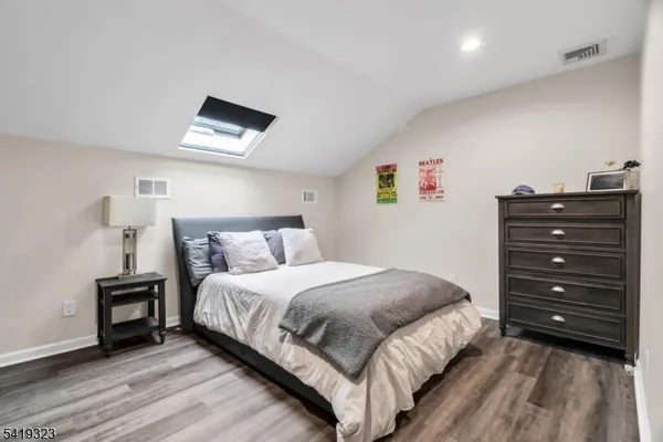 a bedroom with a bed and a tv