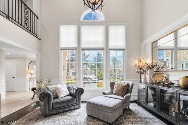 a living room with furniture and a floor to ceiling window