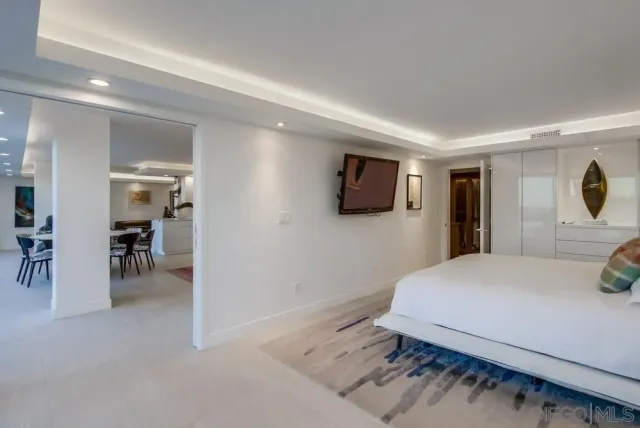 a bathroom with a granite countertop sink a toilet a mirror and shower
