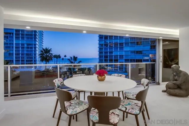 a view of a dining room with furniture and a potted plant