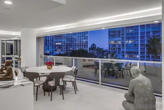 a living room with furniture a large window and a table
