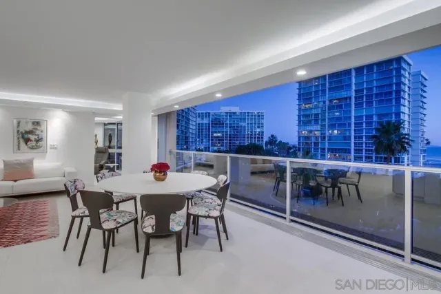 a view of a balcony and dining room