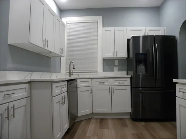 a kitchen with stainless steel appliances a refrigerator sink and cabinets