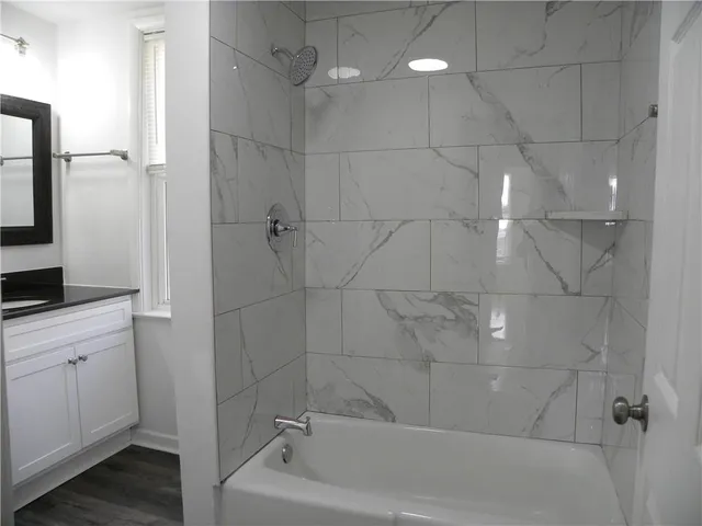 a bathroom with a bathtub and a shower