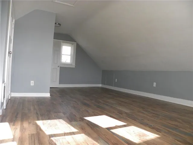 a view of wooden floor and windows in a room