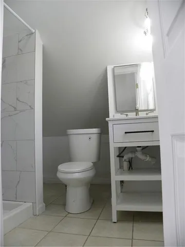 a bathroom with a toilet sink and vanity