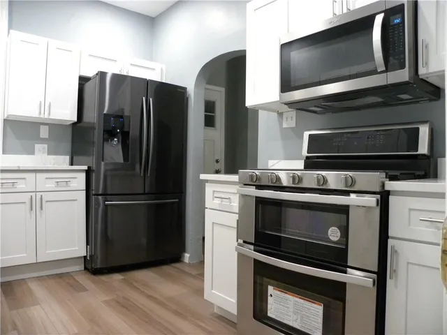 a kitchen with appliances and cabinets
