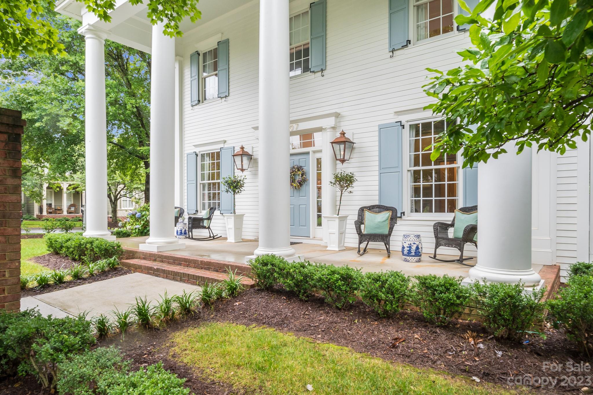 a front view of a house with garden and porch