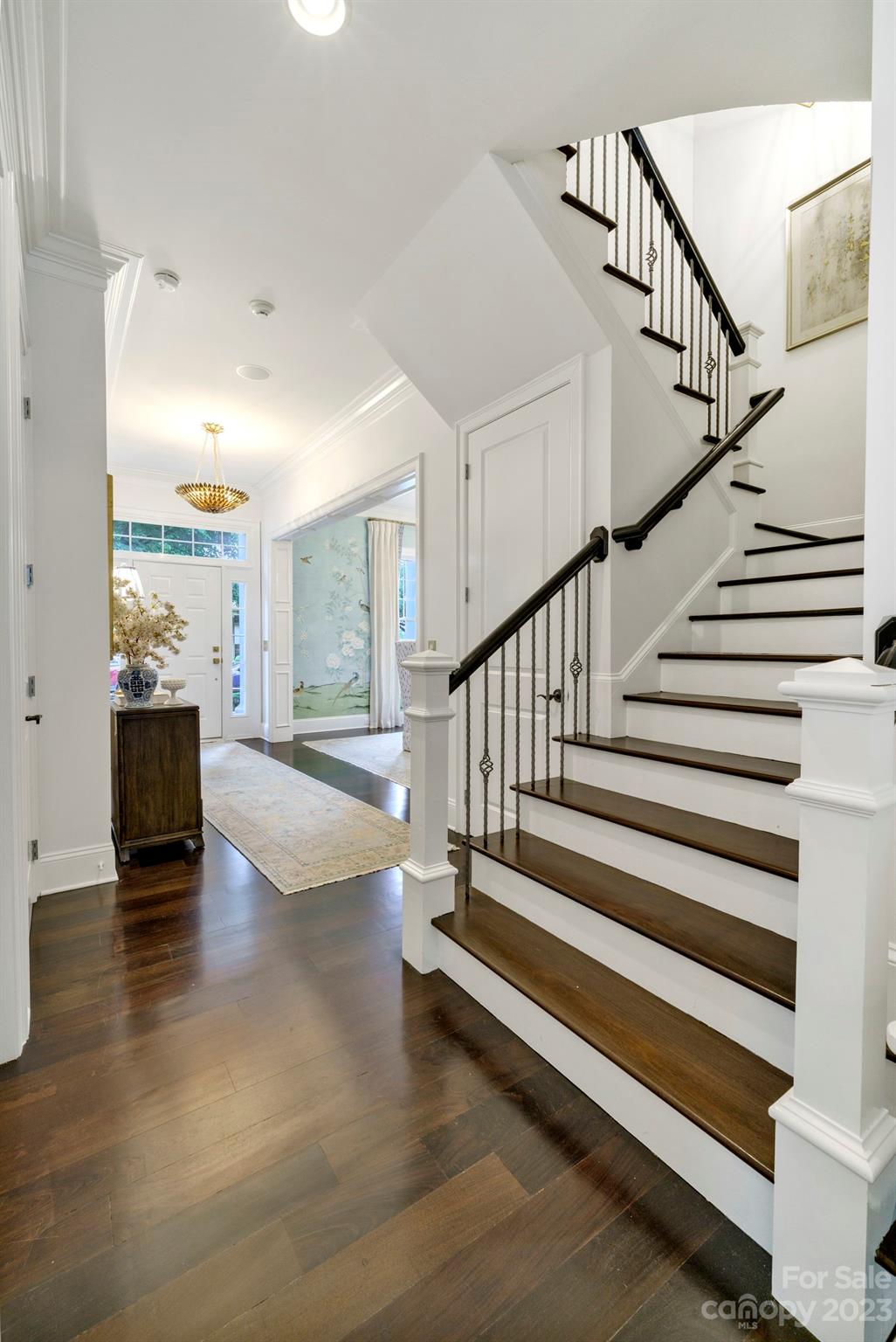 407 Bullfinch Bend Fort Mill, SC 29708 - Photo 14 of 46 a view of staircase with wooden floor and fireplace