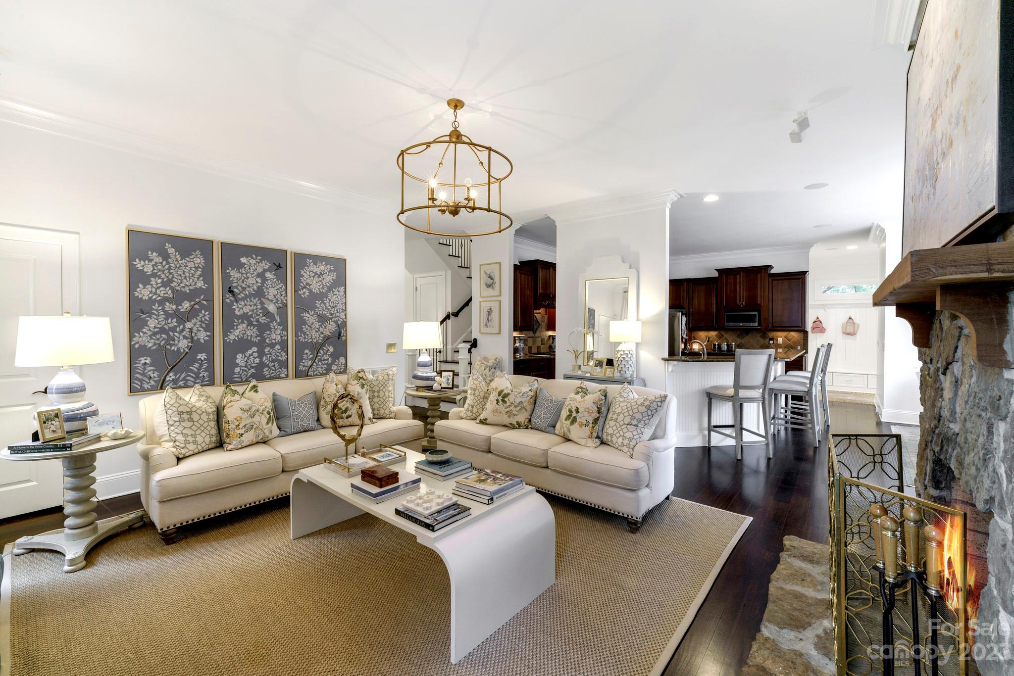 407 Bullfinch Bend Fort Mill, SC 29708 - Photo 16 of 46 a living room with furniture a chandelier and a flat screen tv