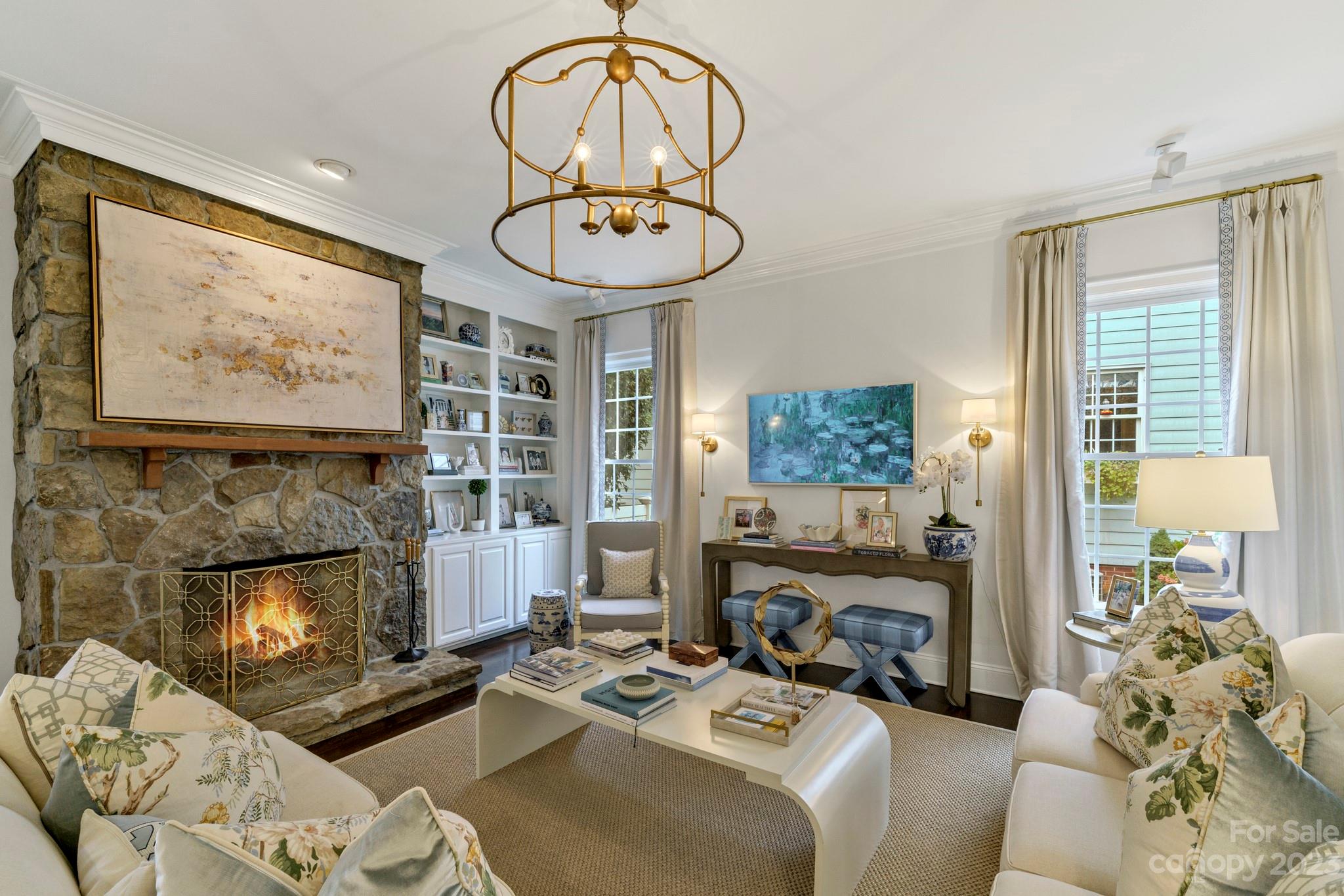 407 Bullfinch Bend Fort Mill, SC 29708 - Photo 18 of 46 a living room with furniture a fireplace and a large mirror