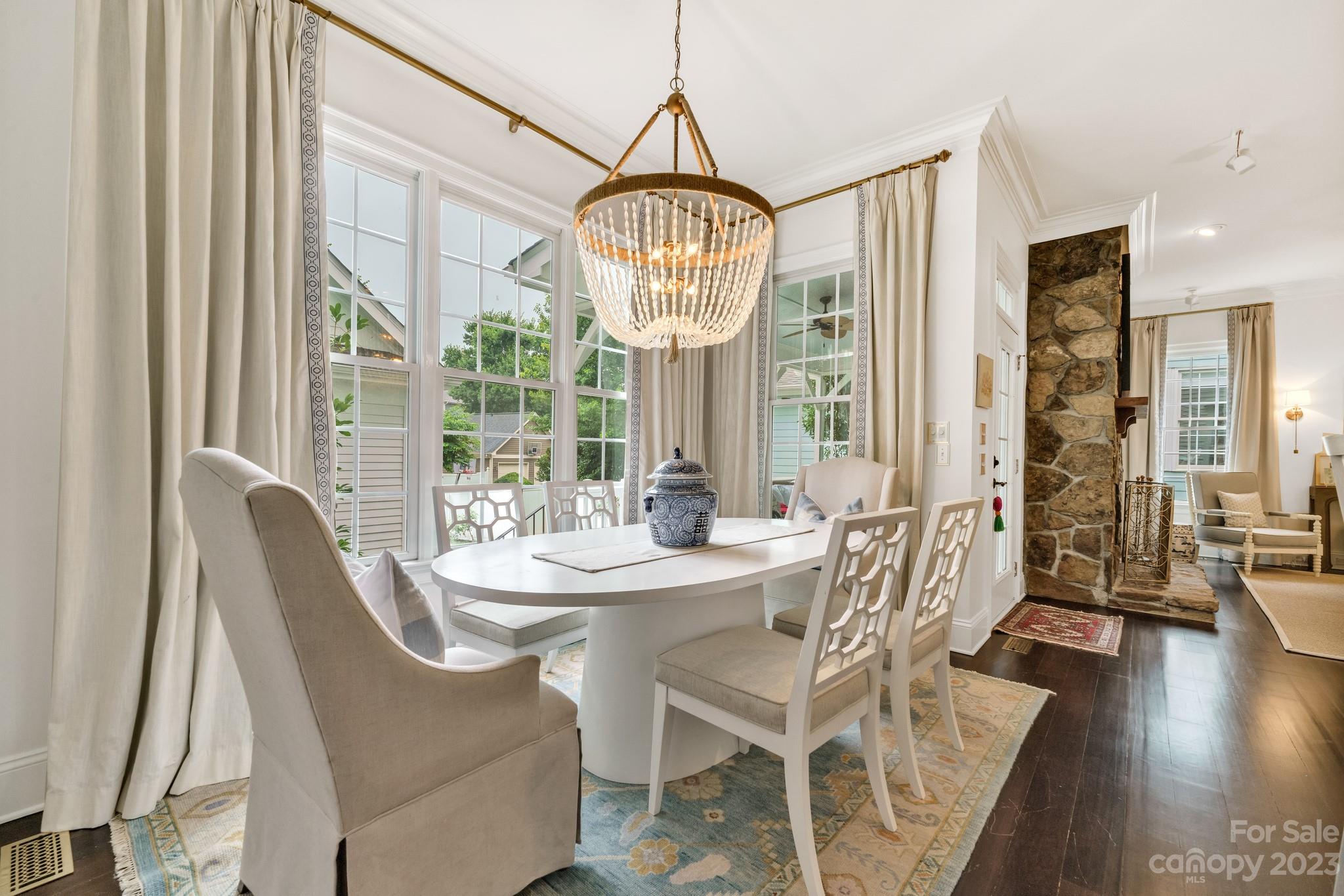 407 Bullfinch Bend Fort Mill, SC 29708 - Photo 19 of 46 a view of a dining room with furniture wooden floor and a chandelier
