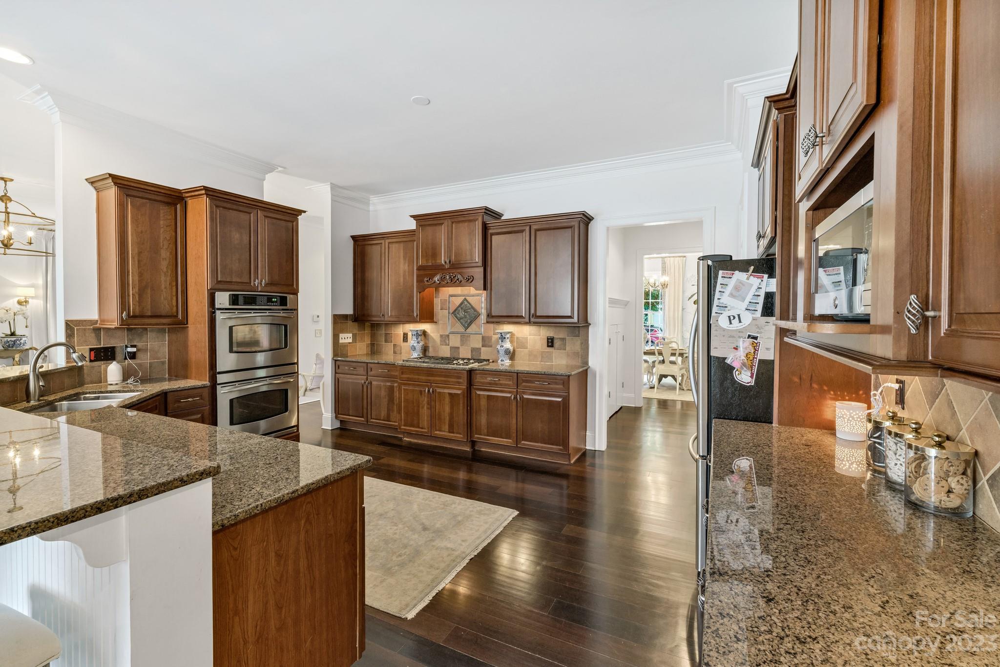 407 Bullfinch Bend Fort Mill, SC 29708 - Photo 21 of 46 a large kitchen with granite countertop a large counter top appliances and cabinets