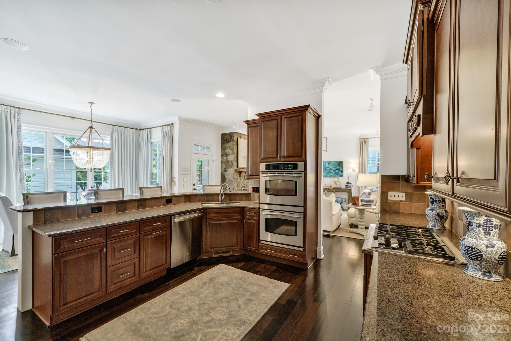 407 Bullfinch Bend Fort Mill, SC 29708 - Photo 23 of 46 a large kitchen with stainless steel appliances granite countertop a stove a sink and a refrigerator