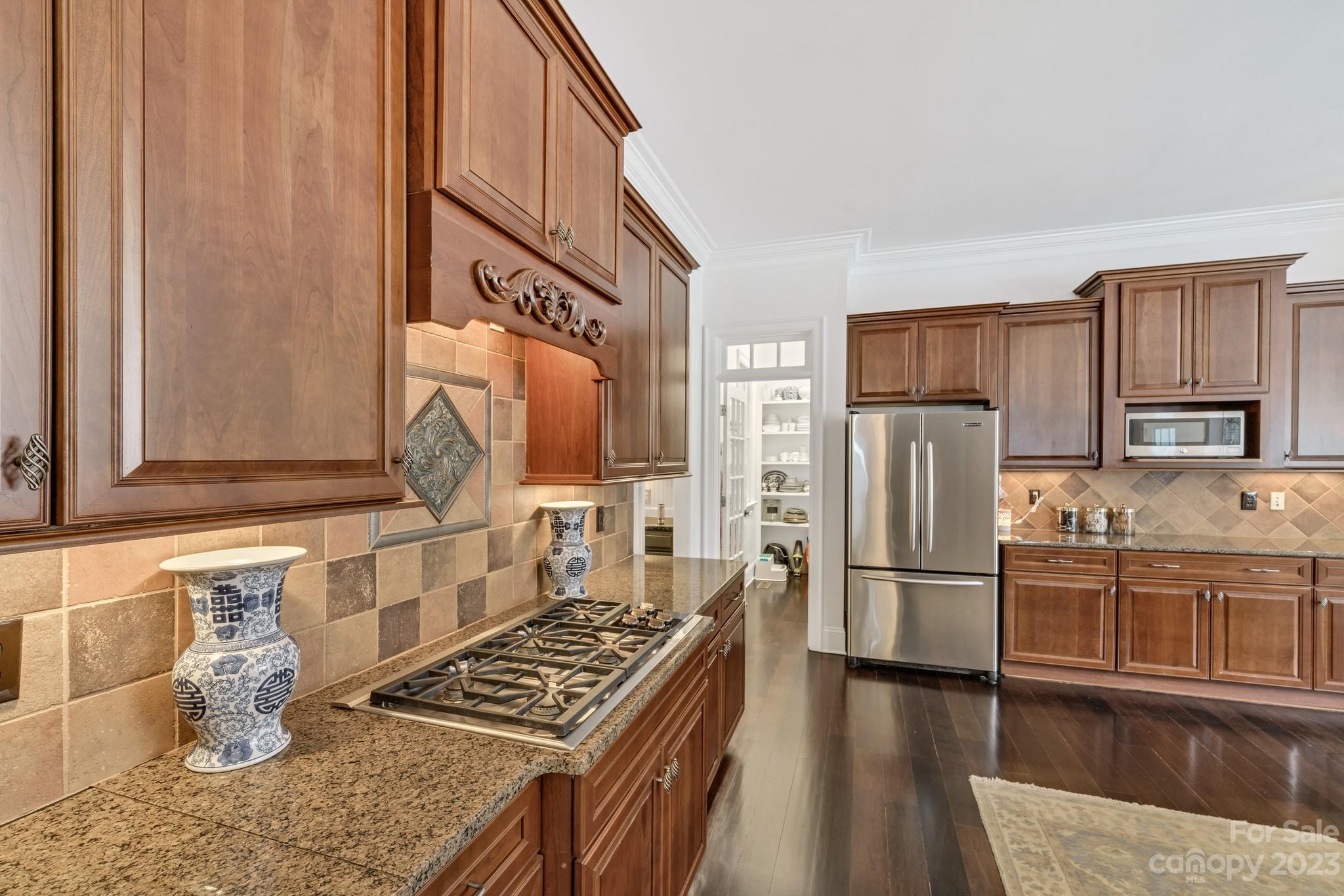 407 Bullfinch Bend Fort Mill, SC 29708 - Photo 24 of 46 a kitchen with granite countertop a refrigerator and a stove top oven