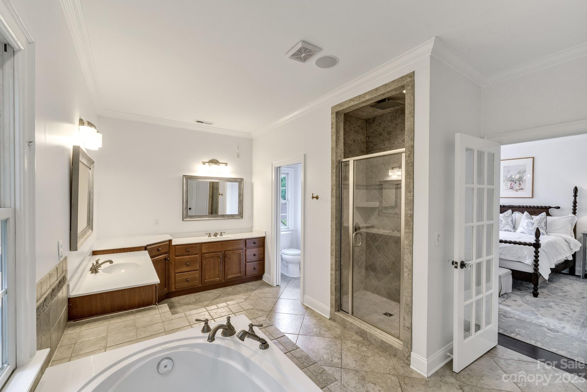 407 Bullfinch Bend Fort Mill, SC 29708 - Photo 34 of 46 a bathroom with a tub sink and mirror