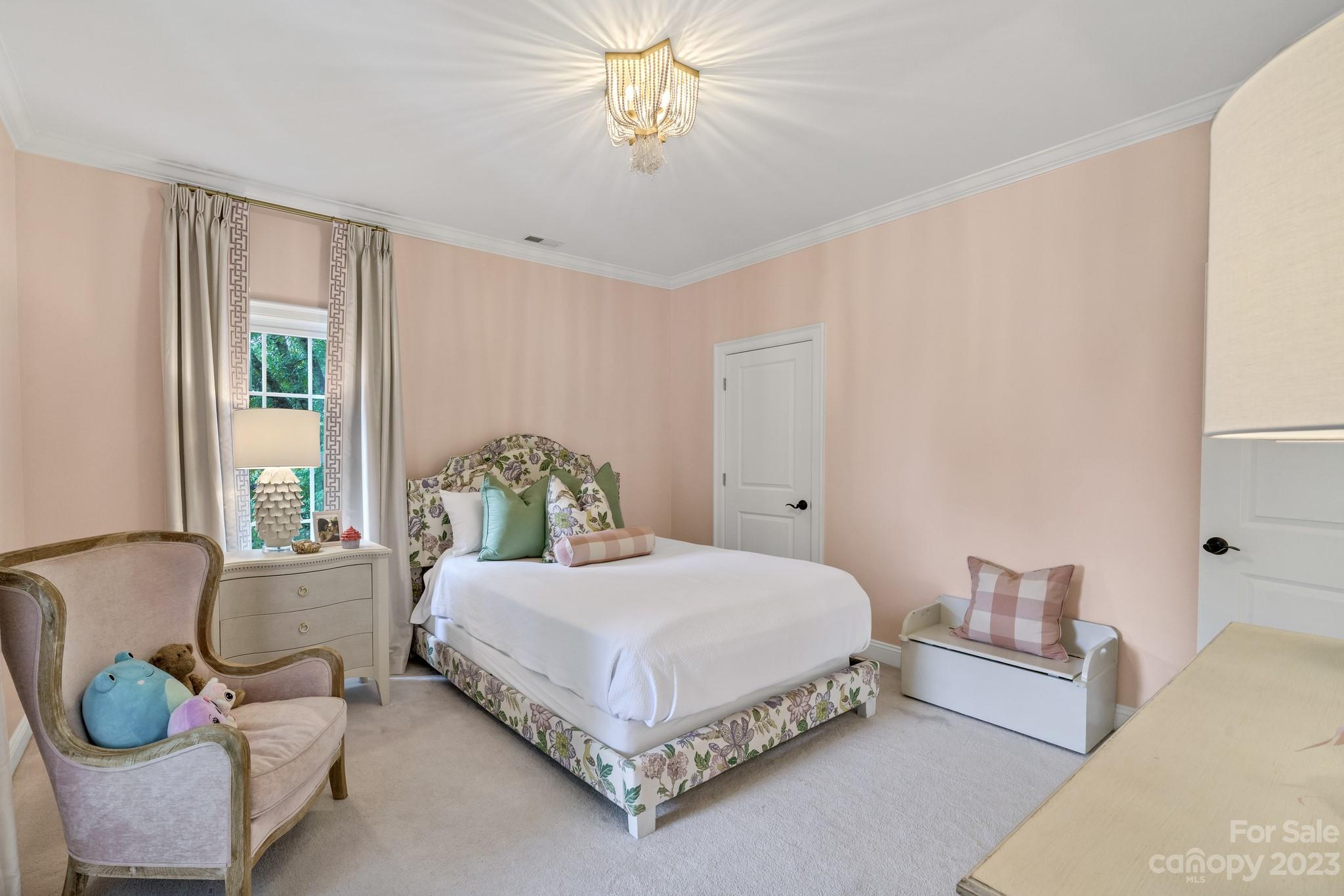 407 Bullfinch Bend Fort Mill, SC 29708 - Photo 35 of 46 a bedroom with a bed and a chandelier