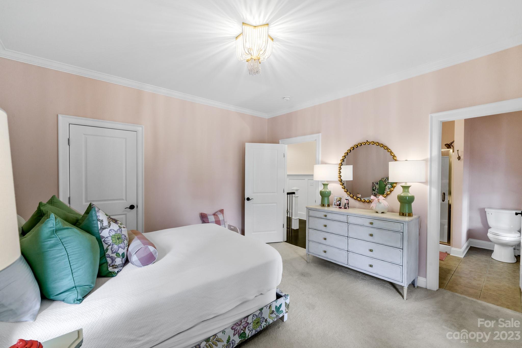 407 Bullfinch Bend Fort Mill, SC 29708 - Photo 36 of 46 a bedroom with a bed and a chandelier