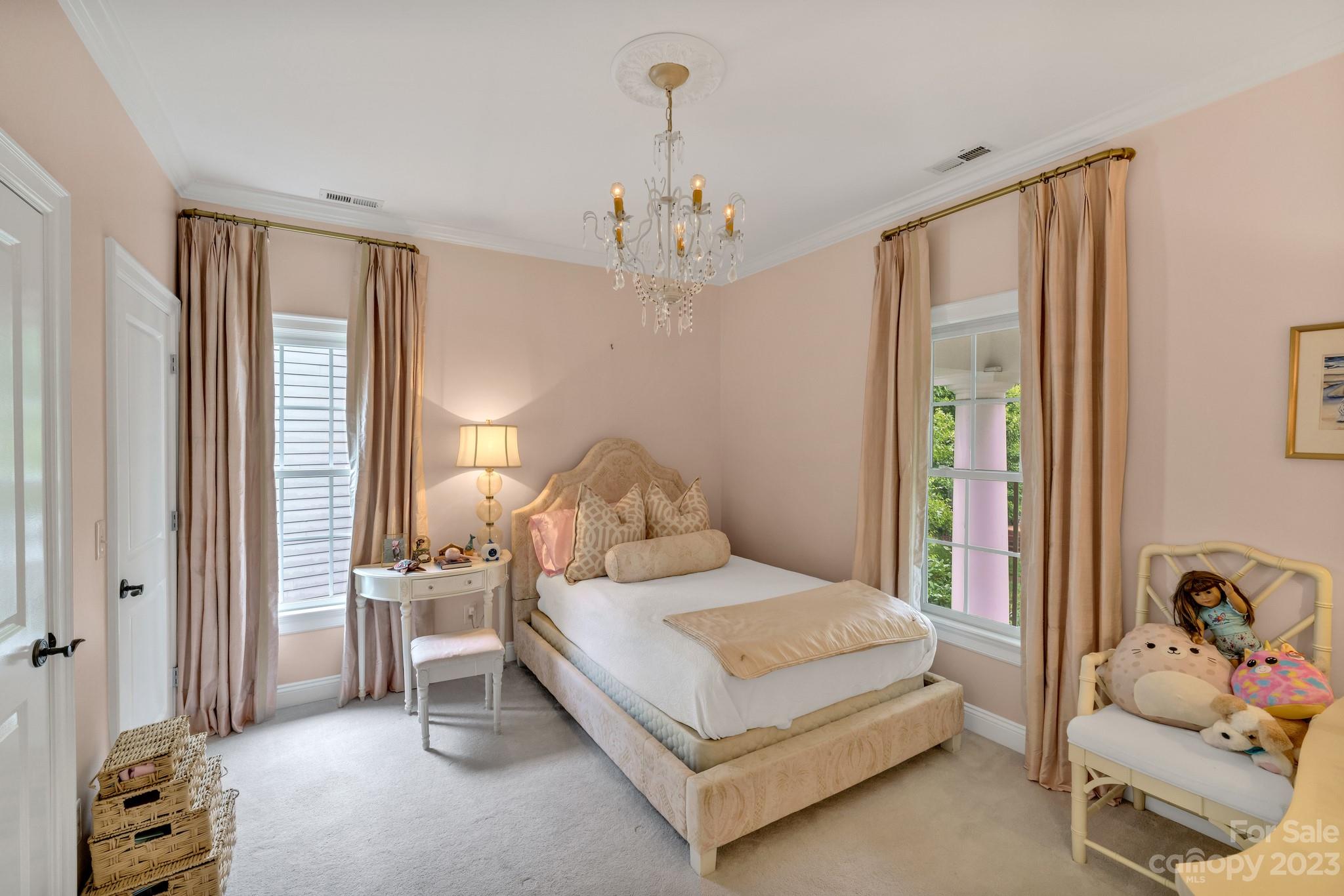 407 Bullfinch Bend Fort Mill, SC 29708 - Photo 37 of 46 a bedroom with a bed and a chandelier