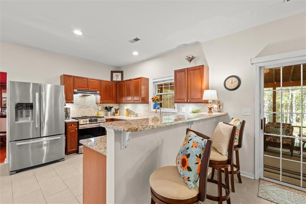 130 Chadwick Place Villa Rica, GA 30180 - Photo 12 of 55 a kitchen with stainless steel appliances granite countertop a refrigerator and a stove top oven