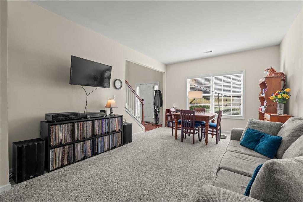 130 Chadwick Place Villa Rica, GA 30180 - Photo 16 of 55 a living room with furniture and a flat screen tv