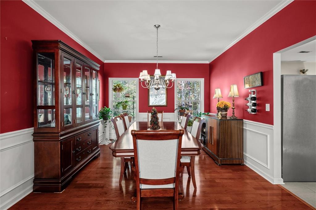 130 Chadwick Place Villa Rica, GA 30180 - Photo 17 of 55 a view of a dining room with furniture a chandelier and wooden floor