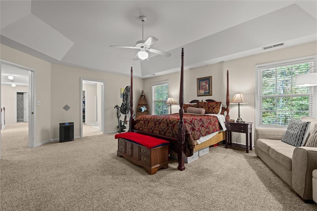 130 Chadwick Place Villa Rica, GA 30180 - Photo 25 of 55 a spacious bedroom with a bed chandelier and a window