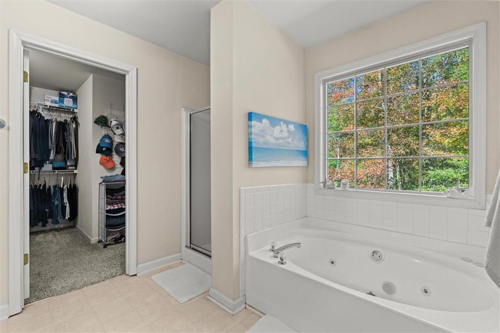 130 Chadwick Place Villa Rica, GA 30180 - Photo 27 of 55 a white bath tub sitting in a en suite bathroom next to a window