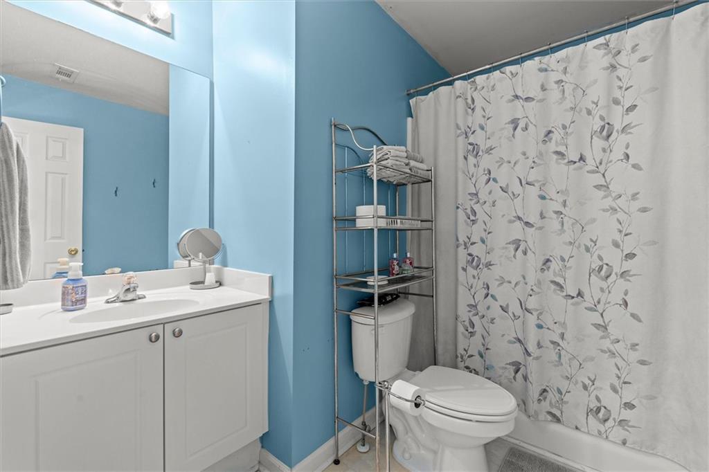130 Chadwick Place Villa Rica, GA 30180 - Photo 34 of 55 a bathroom with a toilet a sink and a mirror