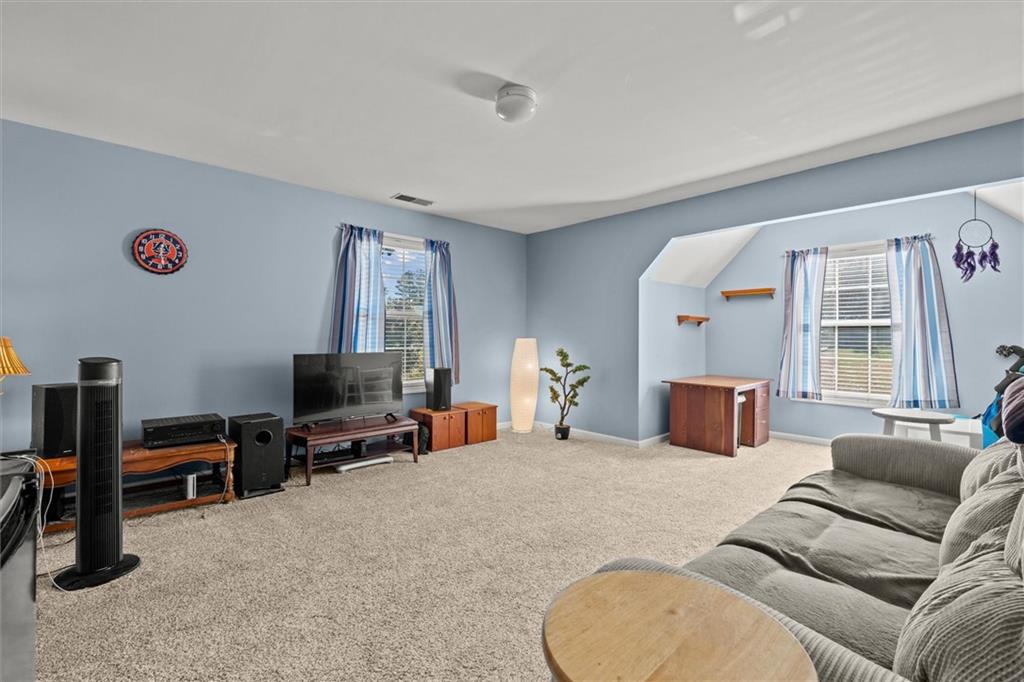 130 Chadwick Place Villa Rica, GA 30180 - Photo 36 of 55 a living room with furniture a flat screen tv and a window