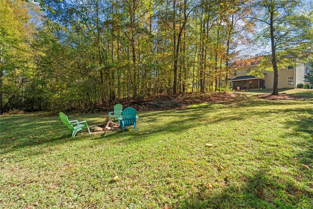 130 Chadwick Place Villa Rica, GA 30180 - Photo 48 of 55 a view of a swimming pool with lawn chairs and a fire pit