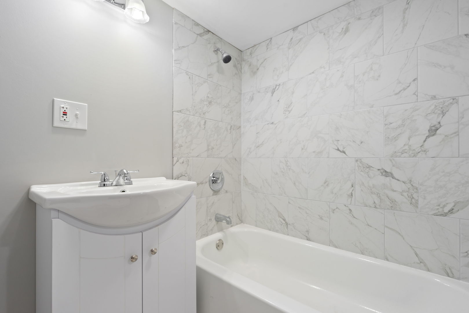 8048 South Avalon Avenue Chicago, IL 60619 - Photo 4 of 17 a bathroom with a sink a bathtub and a shower
