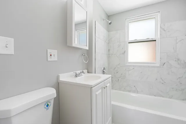 a bathroom with a sink a toilet and bathtub