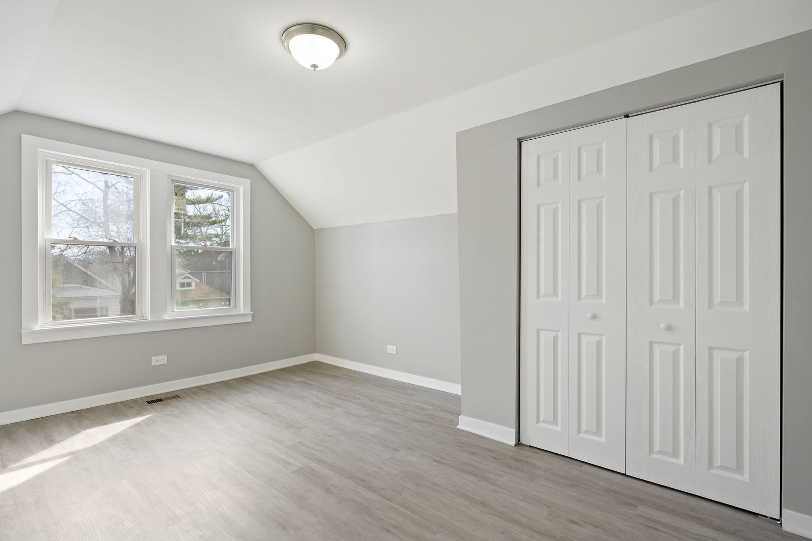8048 South Avalon Avenue Chicago, IL 60619 - Photo 10 of 17 an empty room with wooden floor and windows
