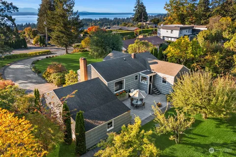 an aerial view of a house with yard swimming pool and outdoor seating